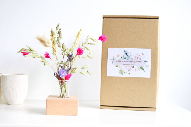 Wooden holder with dried flowers pink